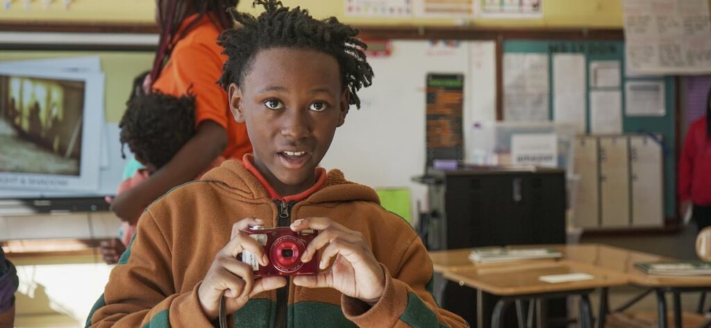 Student holding a camera